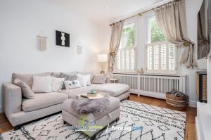 a living room with a couch and a chair at Beautiful 3 BDR House in Windsor Town By Sentinel Living Short Lets & Serviced Accommodation Windsor Ascot Maidenhead With Pet Friendly & Superfast Wifi in Windsor