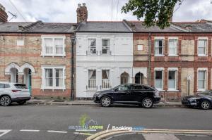 a black car parked in front of a white building at Beautiful 3 BDR House in Windsor Town By Sentinel Living Short Lets & Serviced Accommodation Windsor Ascot Maidenhead With Pet Friendly & Superfast Wifi in Windsor