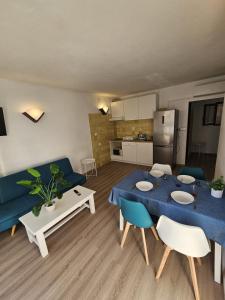 a living room with a blue table and a blue couch at Le Mirage Ibiza in San Antonio