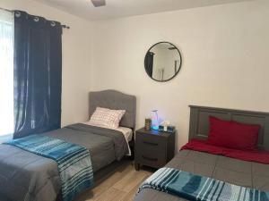 a bedroom with two beds and a mirror on the wall at *Msg for 5%off*3Bed2Bath KingQueenTwins 4Beds PHX in Phoenix