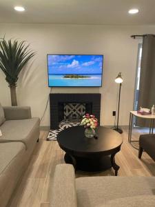 a living room with a tv above a fireplace at *Msg for 5%off*3Bed2Bath KingQueenTwins 4Beds PHX in Phoenix
