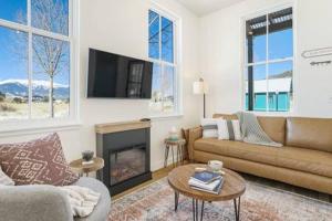 a living room with a couch and a fireplace at Alpine Estate 3 Kitchens & Mountain Views in Buena Vista +46 photos