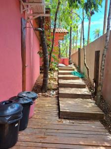 a wooden walkway with trash cans on the side of a house at Casa Rustica Dubanza in Bonito