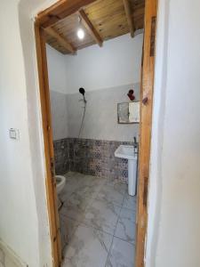 a bathroom with a toilet and a sink at Badya Camp Dahab in Dahab