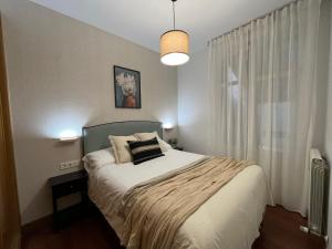 Schlafzimmer mit einem Bett und einem großen Fenster in der Unterkunft Old Town Core next to Plaza Nueva in Bilbao