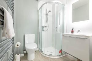 a white bathroom with a shower and a toilet at Argyle Rigg - Central Elegant Townhouse - Balcony in St Andrews