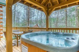 a large hot tub on a screened in porch at Gatlinburg Home with Mountain Views in Gatlinburg
