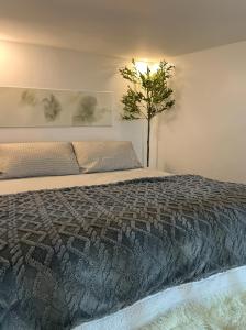 a bedroom with a bed with a tree in it at Lanara House in Magalang