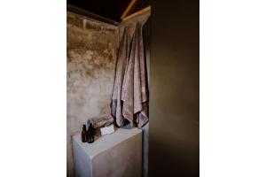 a room with towels on a wall and a wall at Mountain Peak Game Lodge and Camping in Outjo