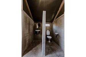 a bathroom with a toilet and a sink at Mountain Peak Game Lodge and Camping in Outjo