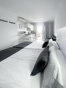 a large bed with pillows on it in a room at Apartamentos Pez Azul in Puerto de la Cruz