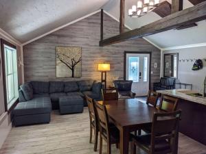a living room with a couch and a table at Chalet lacbrome in Lac-Brome