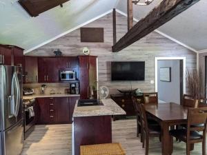 a kitchen with a table and a dining room at Chalet lacbrome in Lac-Brome