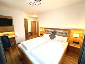 a bedroom with a large white bed and a desk at Gasthaus Rotes Ross in Eckental