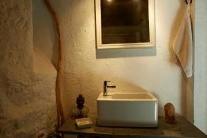 a bathroom with a white sink and a mirror at Wild Valley Rustico Style in Valle Onsernone in Auressio