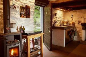 a kitchen with a stove and a fireplace at Wild Valley Rustico Style in Valle Onsernone in Auressio