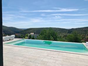 a swimming pool with a view of a mountain at CHALET NUEVO EN LA MONTAÑA, CON CHIMENEA in Torremocha de Jarama