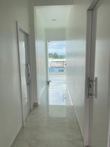 a hallway with an open door with a view of a pool at Suíte Festival de Parintins I in Parintins