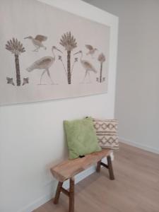 a bench in a room with a picture of birds at DuplexJacob2 in Antwerp