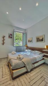 a bedroom with a large bed and a window at Roma Caracalla apartament with garden in Rome
