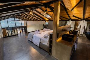 a bedroom with a large bed and a sink at Spa Villas Nafpaktos in Nafpaktos