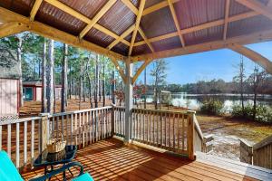 a large wooden deck with a view of a lake at The Lake Keziah House in Southport