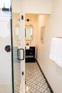 a bathroom with a sink and a mirror at Speakeasy Queen Suite (Rm 7) in Nevada City