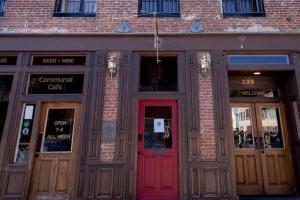 a brick building with a red door and windows at Speakeasy Suites Sleeps 18 in Nevada City