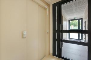 an empty hallway with a door and a window at La Résidence Alpha Viroflay 101 - 1 chambre - 4 pers in Viroflay