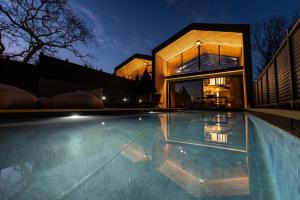 a large swimming pool in front of a house at Spa Villas Nafpaktos in Nafpaktos