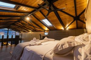 a bedroom with two beds with towels on them at Spa Villas Nafpaktos in Nafpaktos