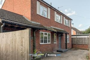 a brick house with a wooden fence in front of it at Ascot, Pet Friendly, Detached 4 Bedroom House By Sentinel Living Short Lets & Serviced Accommodation Windsor Ascot Maidenhead With Free Parking in Ascot