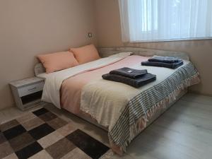 a bedroom with a bed with two towels on it at City Apartment in Gotse Delchev