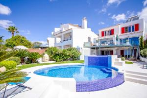 a villa with a swimming pool in front of a house at Villa de la Plage in Albufeira