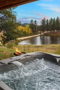 a boat in the water with a fire in it at Sun Filled Joy BHBungalows #8 in Custer