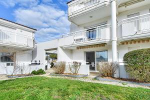 une vue extérieure d'un bâtiment blanc avec une cour dans l'établissement Escapade tout près du Port et de la plage, à Saint-Gilles-Croix-de-Vie