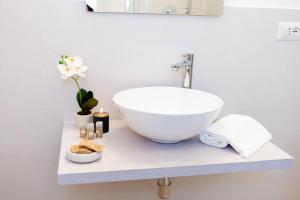 a bathroom with a bowl sink on a counter at Estia Suites in Villasimius