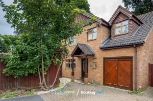 a brick house with a wooden garage at 4 Bedroom House By Sentinel Living Short Lets & Serviced Accommodation Windsor Ascot Maidenhead With Free Parking & Pet Friendly in Maidenhead
