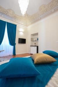 a bedroom with a blue bed and blue curtains at Rosetta Burger Queen in Cagliari