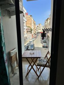 a table on a balcony with a view of a street at Dar Esslam Studio Moderne in Casablanca