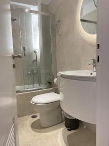 a bathroom with a toilet and a shower and a sink at Four Seasons Sea View Apartment in Athens +36 photos