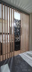 a bedroom with a wooden fence and a bed at olivegrove in Sidari