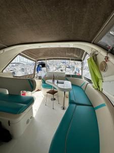 a room with a table and chairs in a boat at Le Grand Bleu - idéal Festival de Cannes in Cannes