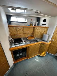 a small kitchen in an rv with a sink at Le Grand Bleu - idéal Festival de Cannes in Cannes