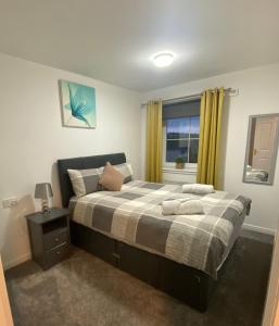 a bedroom with a bed and a window at Duloch Bridge View in Dunfermline
