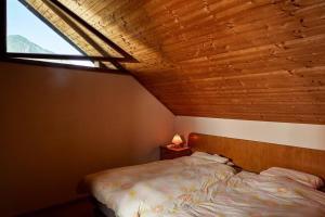 a small bedroom with a bed and a window at Wild Valley Village Life Apartment in Onsernone in Loco