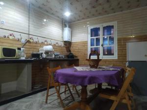 a kitchen with a table with a purple table cloth at Bel appartement in El Kala