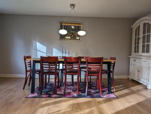 a dining room with a table and chairs at Charming Swedish Cottage from 1909 in Markaryd