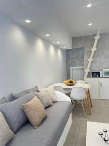 a living room with a gray couch and a table at Villa Family in Emporio