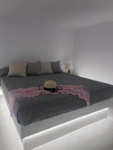 a large bed with a hat on top of it at Villa Family in Emporio